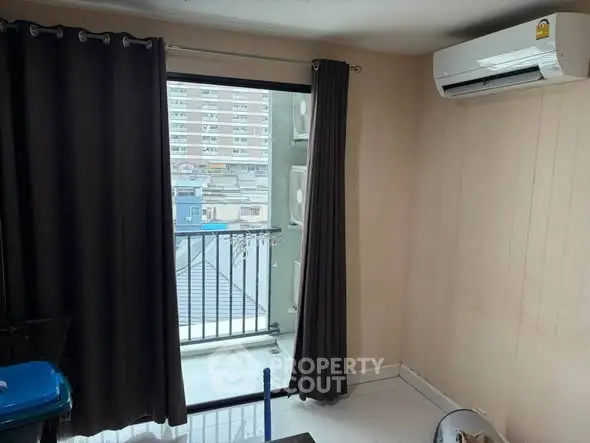 Cozy room with balcony access and air conditioning in urban apartment