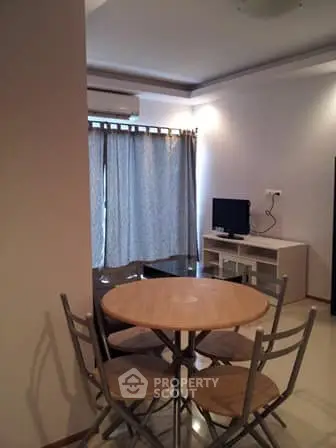 Cozy living room with dining area and natural light, perfect for relaxation and entertainment.