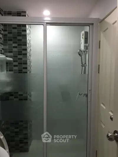 Modern bathroom with glass shower enclosure and stylish tile design