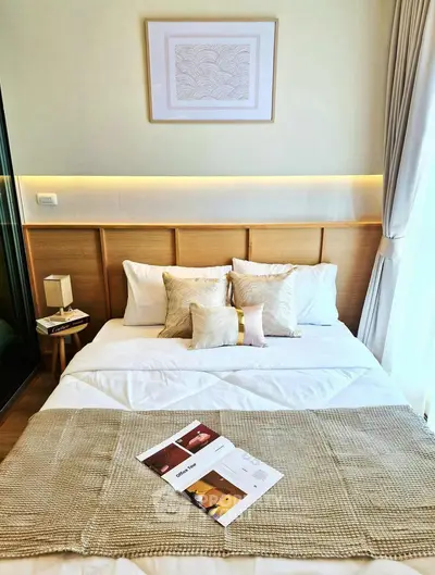 Cozy bedroom with stylish decor and natural light, perfect for relaxation.