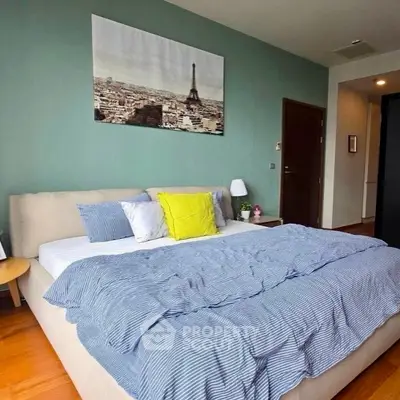 Cozy bedroom with stylish decor and cityscape artwork, featuring a comfortable bed and modern design.