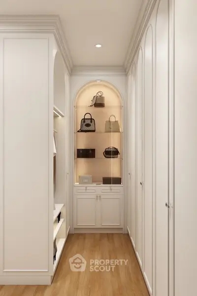Luxurious walk-in closet with elegant cabinetry and display shelves for handbags.
