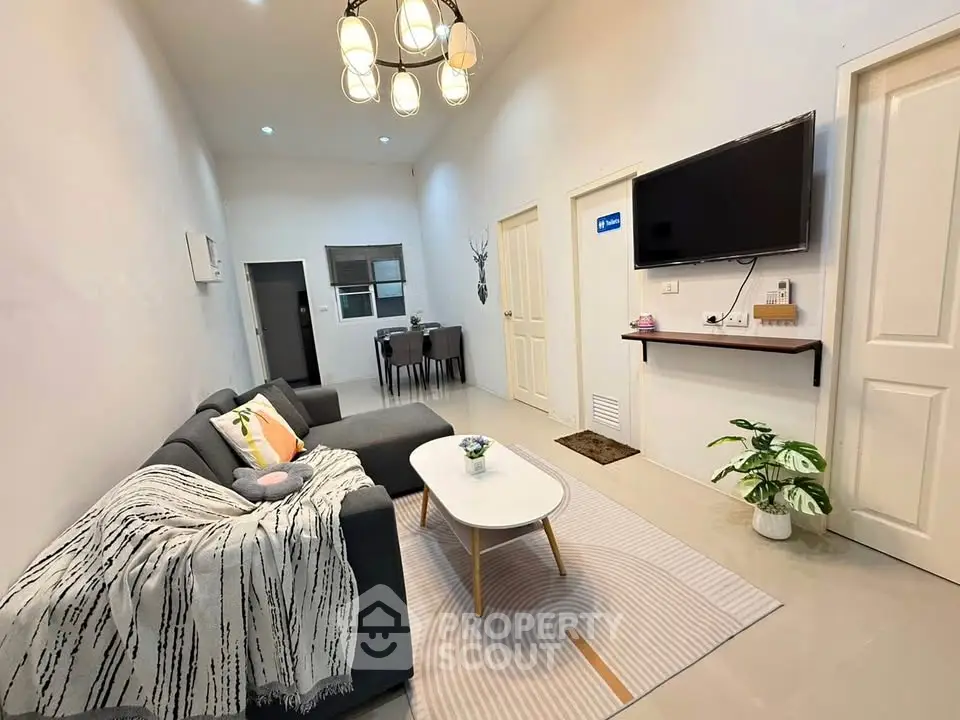 Cozy living room with modern decor and wall-mounted TV