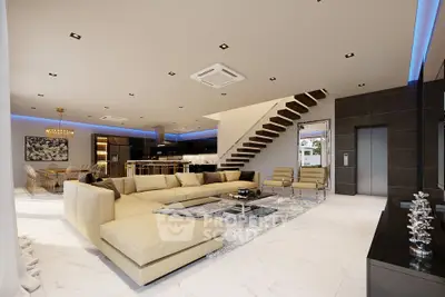 Luxurious open-plan living room with modern decor and elegant staircase