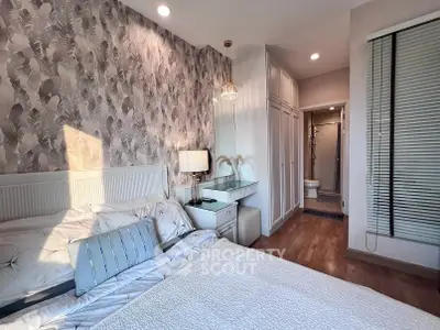 Chic bedroom with stylish wallpaper and ensuite bathroom in modern apartment