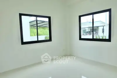 Bright empty room with large windows and glossy white floor