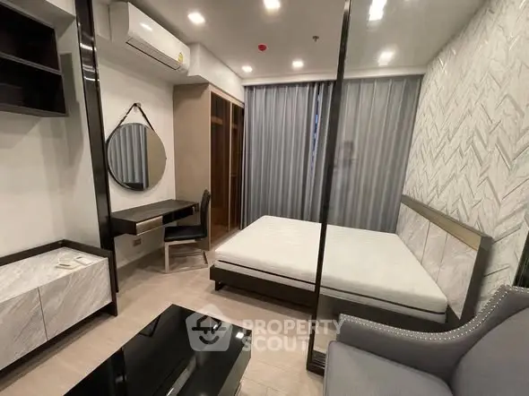 Modern bedroom with stylish decor and ample natural light