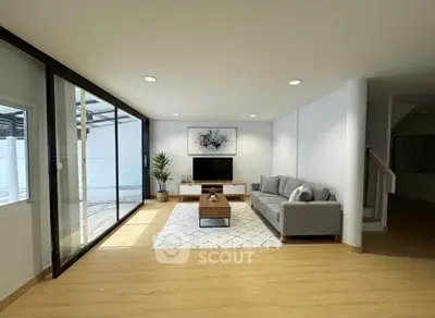 Spacious modern living room with large windows and stylish decor