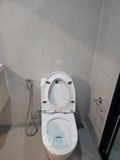 Modern bathroom with sleek toilet and bidet spray