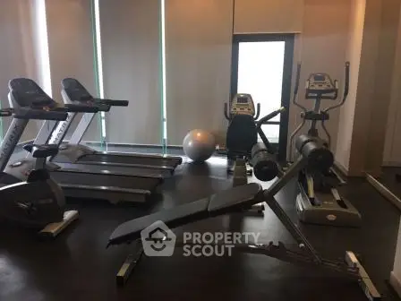 Modern gym with treadmills and exercise equipment in a residential building.
