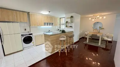 Spacious kitchen and dining area with modern appliances and stylish decor.