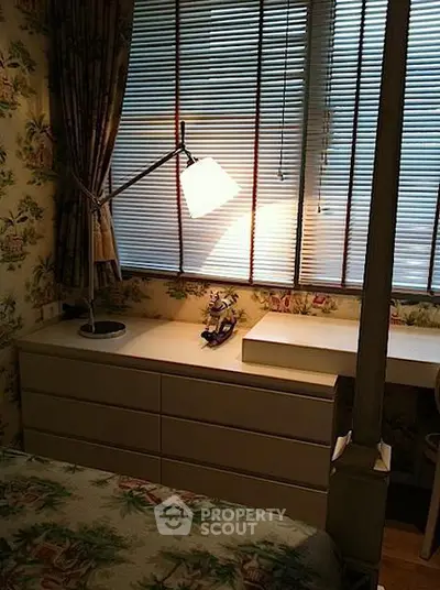 Cozy bedroom with floral wallpaper and modern desk lamp