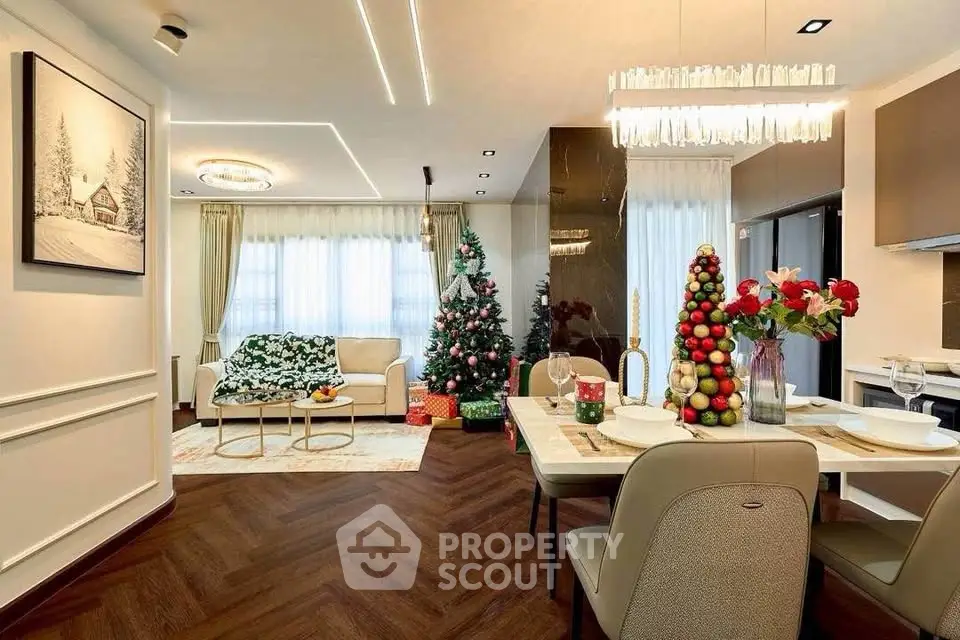 Elegant living and dining area with festive Christmas decor and modern lighting.