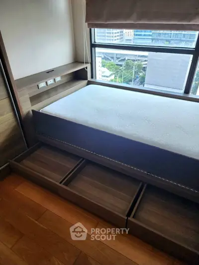 Modern bedroom with storage bed and city view window