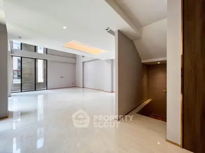 Spacious modern living room with high ceilings and large windows