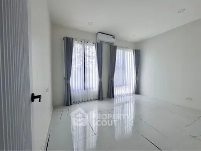 Spacious and bright empty room with large windows and modern tile flooring, perfect for customization.
