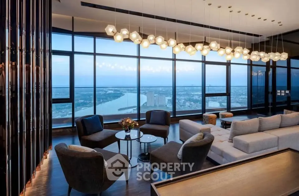 Luxurious living room with panoramic city and river views, featuring modern furniture and elegant lighting.