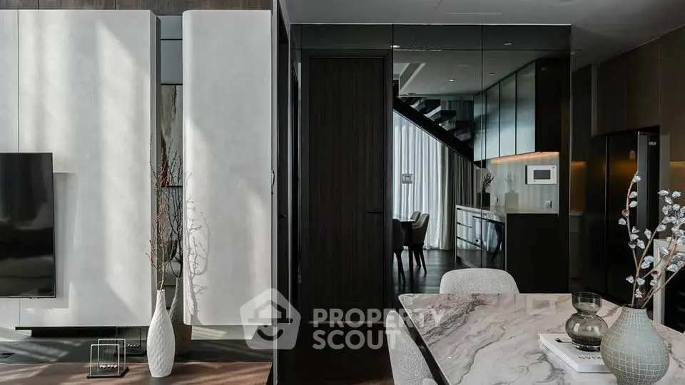 Luxurious modern living room with elegant marble dining table and sleek interior design.