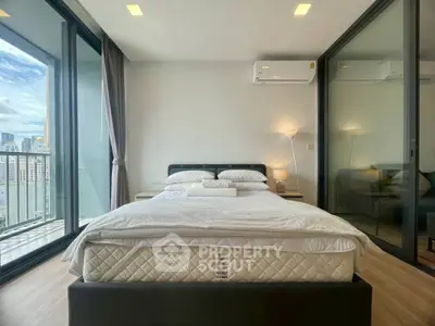 Modern bedroom with city view and balcony access in luxury apartment.