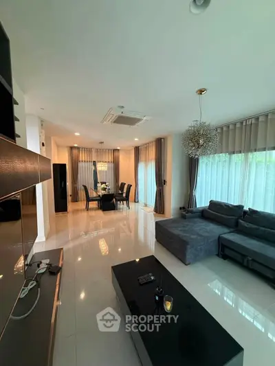 Spacious modern living room with elegant dining area and large windows