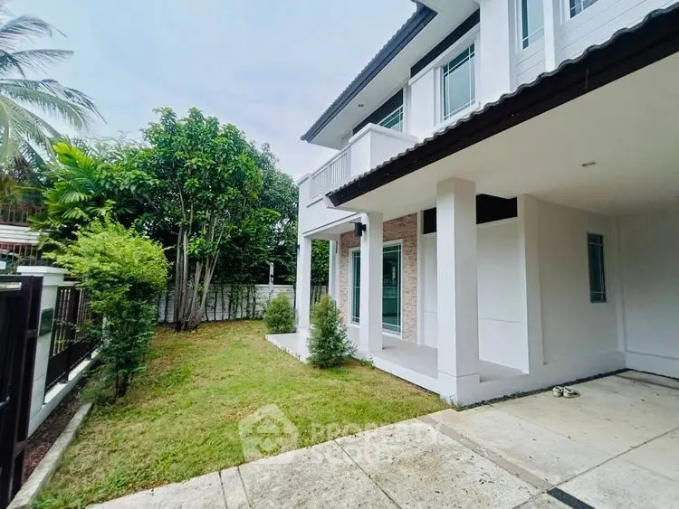 Charming two-story house with lush garden and modern architecture