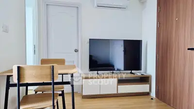 Modern living room with sleek TV setup and minimalist dining area