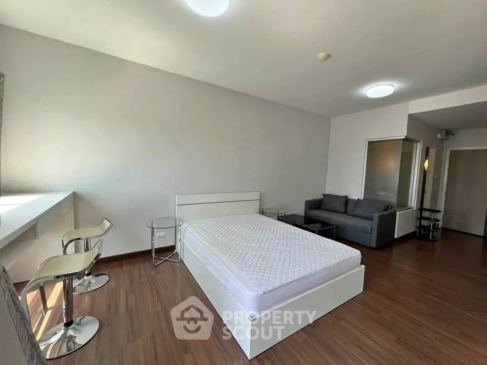 Spacious modern bedroom with sleek furniture and natural light