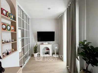 Stylish living room with modern decor and large windows for natural light.