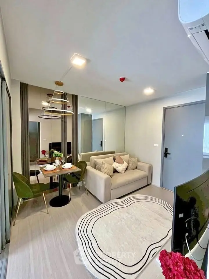 Modern living room with cozy sofa, dining area, and stylish decor in a compact apartment.