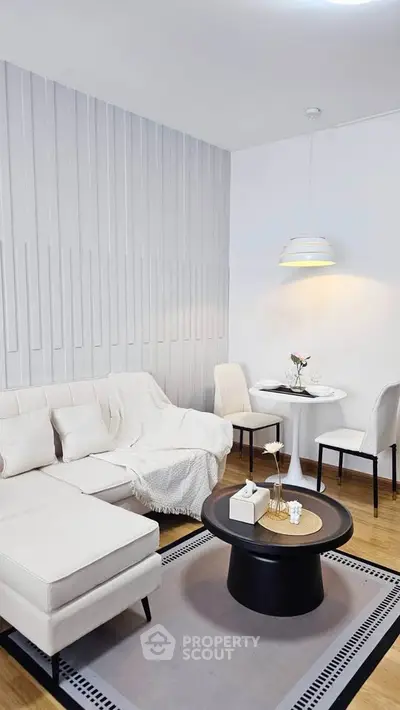 Modern living room with elegant white furniture and cozy dining area