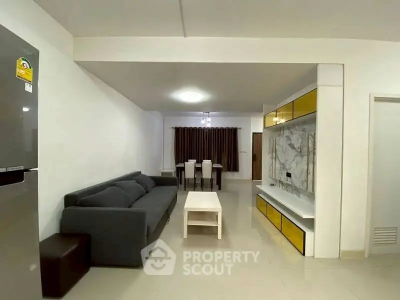 Spacious living room with modern sofa and elegant dining area