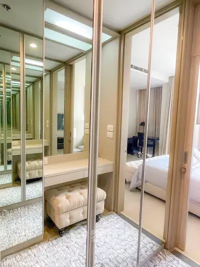 Luxurious bedroom with mirrored closet doors and elegant decor