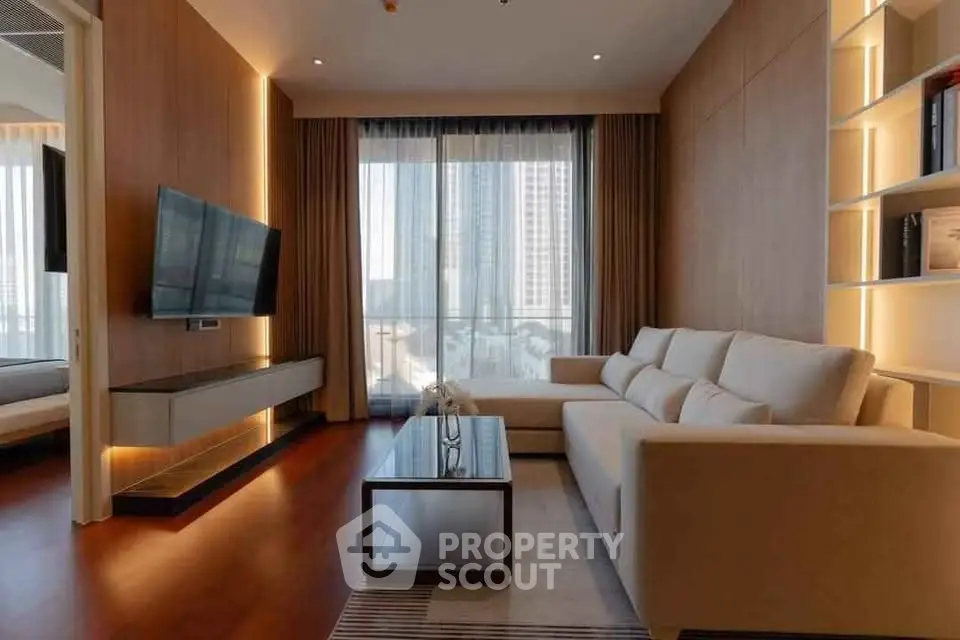 Modern living room with large windows and city view, featuring sleek furniture and elegant decor.
