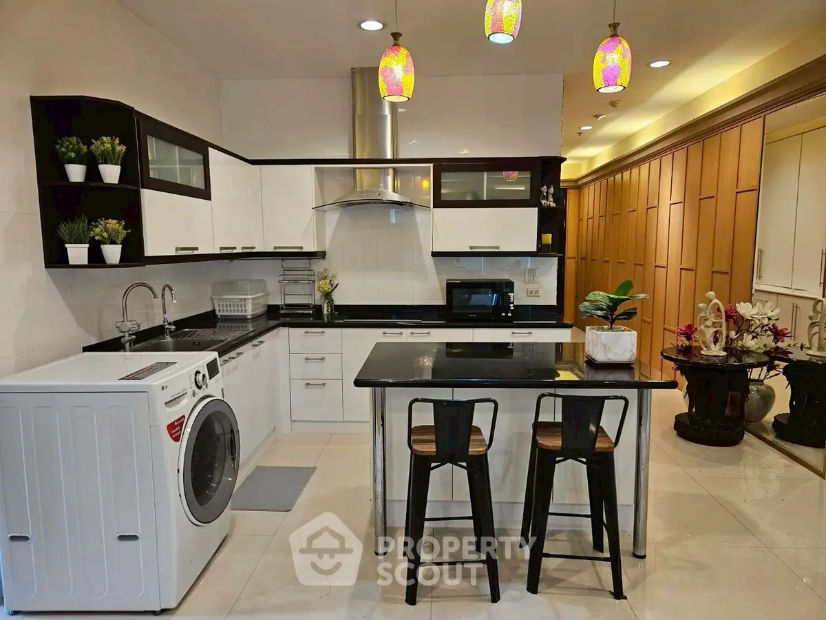 Modern kitchen with sleek design, featuring island seating and built-in appliances for a stylish culinary experience.