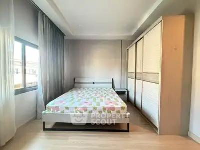 Spacious bedroom with modern design and ample natural light