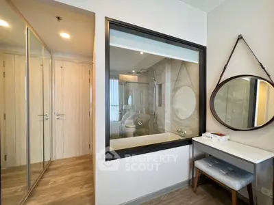 Modern bedroom with glass wall bathroom and stylish vanity area