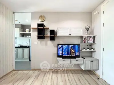 Modern living room with stylish wall-mounted TV and open kitchen view