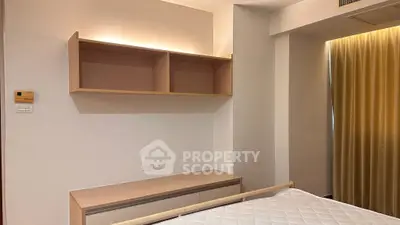 Modern bedroom with built-in shelves and soft lighting