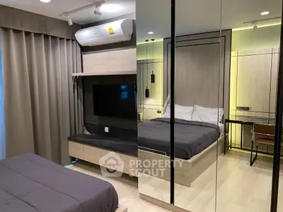 Modern bedroom with mirrored wardrobe and sleek design in a stylish apartment.