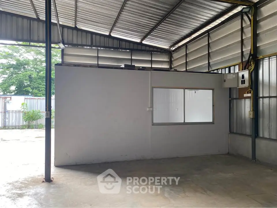 Spacious industrial warehouse with metal roofing and concrete flooring