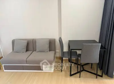 Modern living room with stylish sofa and dining table in a cozy apartment.