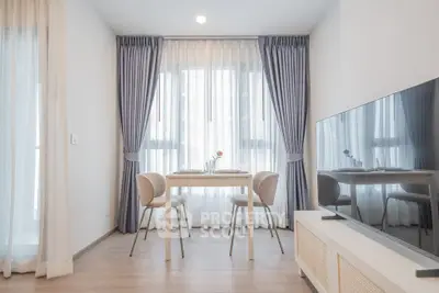 Bright and modern dining area with elegant curtains and sleek furniture