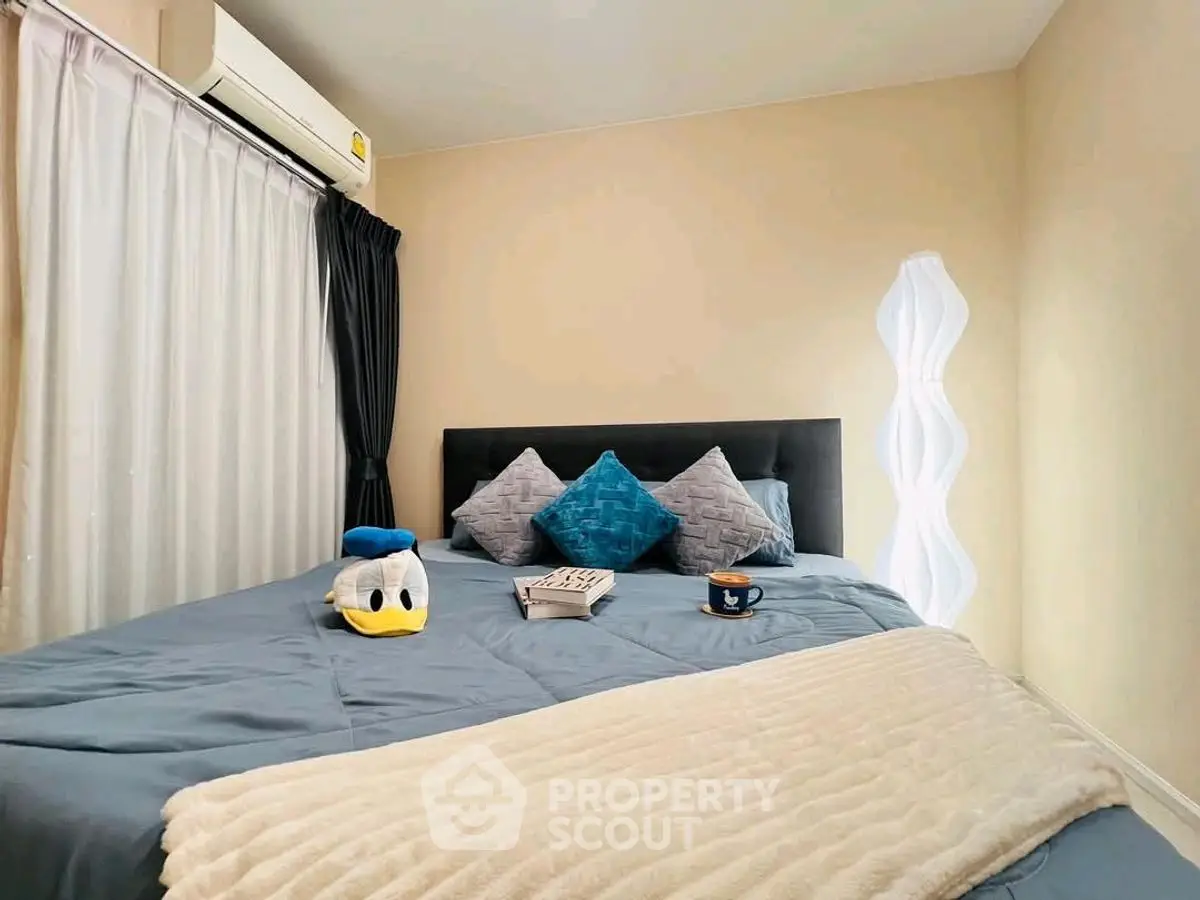 Cozy bedroom with plush bedding, stylish pillows, and modern lighting