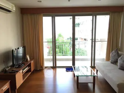 Spacious living room with modern furniture and large balcony view.