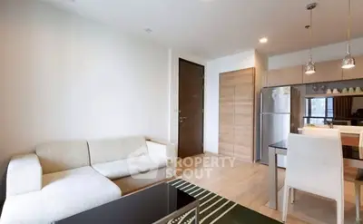 Modern living room with cozy sofa and stylish kitchen area