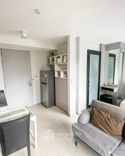 Modern living room with compact kitchen and sleek design