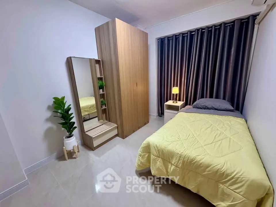 Cozy bedroom with modern wardrobe and stylish decor in a contemporary apartment.