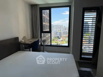 Modern bedroom with city view and balcony access in urban apartment