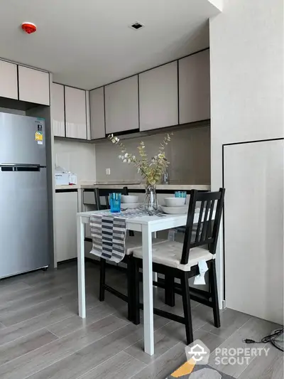 Modern kitchen with dining area featuring sleek cabinets and stylish decor