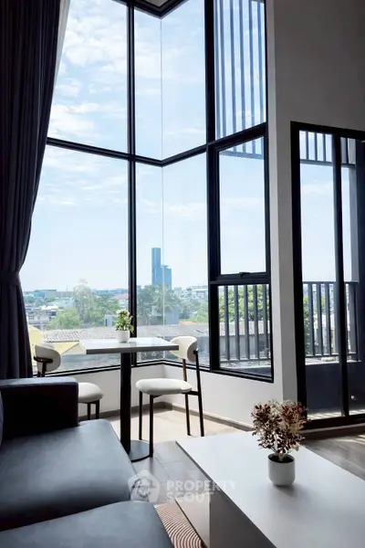 Modern living room with floor-to-ceiling windows and stunning city view